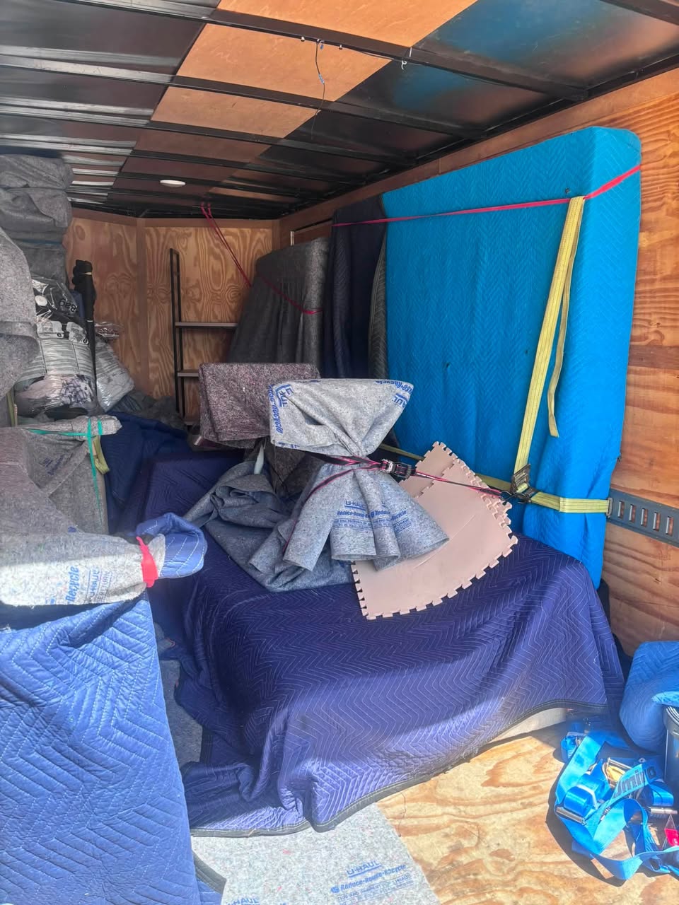Furniture securely wrapped and strapped inside a Three Brothers Moving ATX trailer